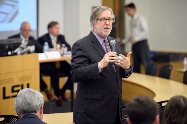 Brian Andrews speaks to audience using microphone.