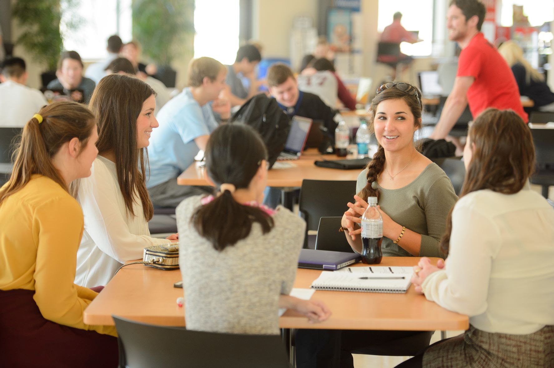 Female students study at table in BEC Rotunda