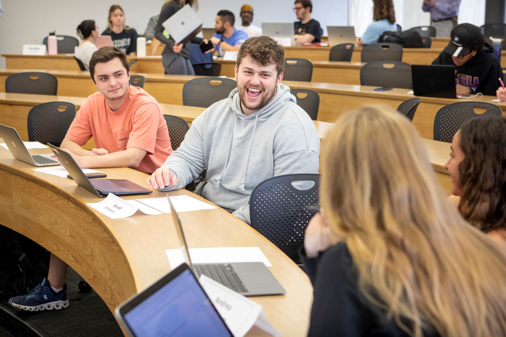 Students laugh in a classroom.