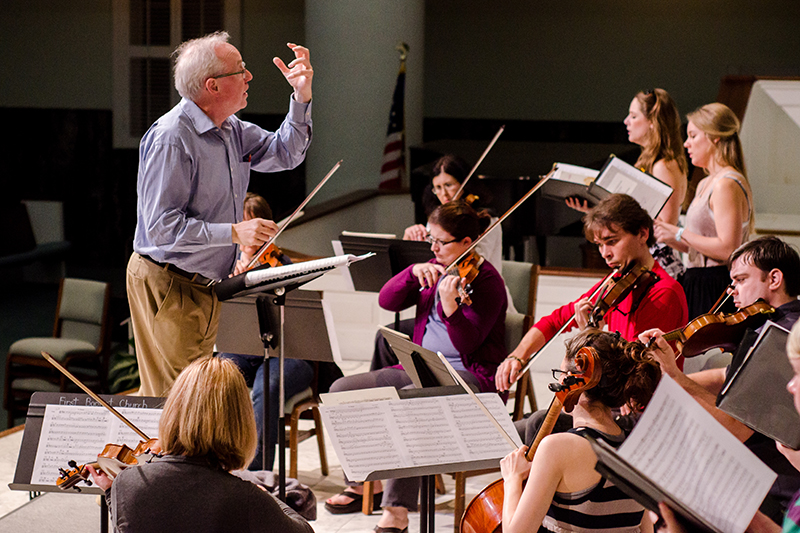 man conducting orchestra