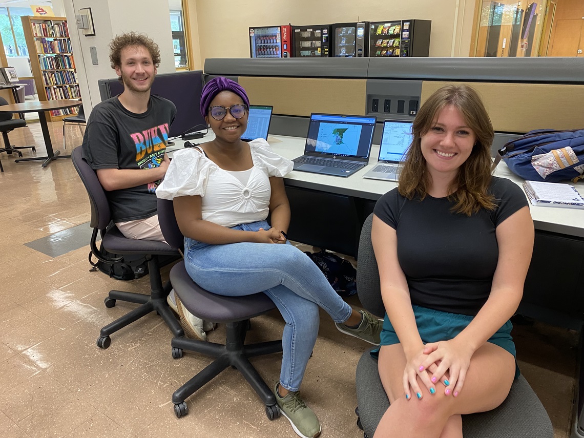 Three students working at computers