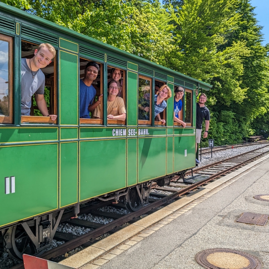 students ride a train