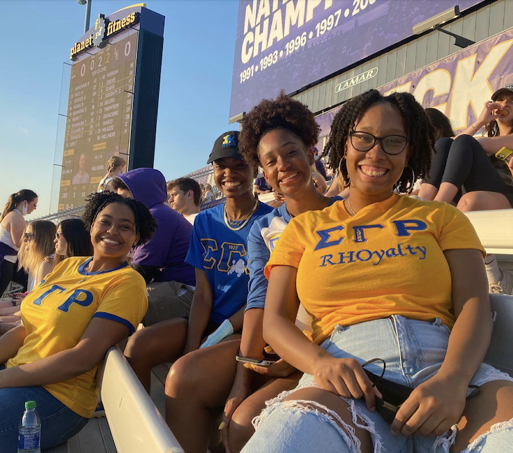 sigma gamma rho members at game in stadium