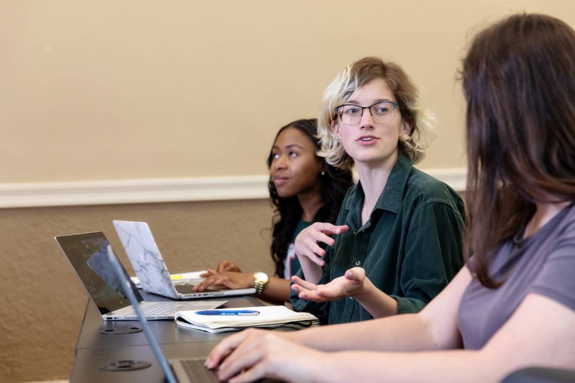 Students talking at a desk