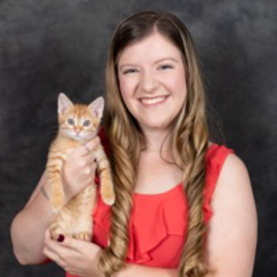 Marianna and a young orange cat. 